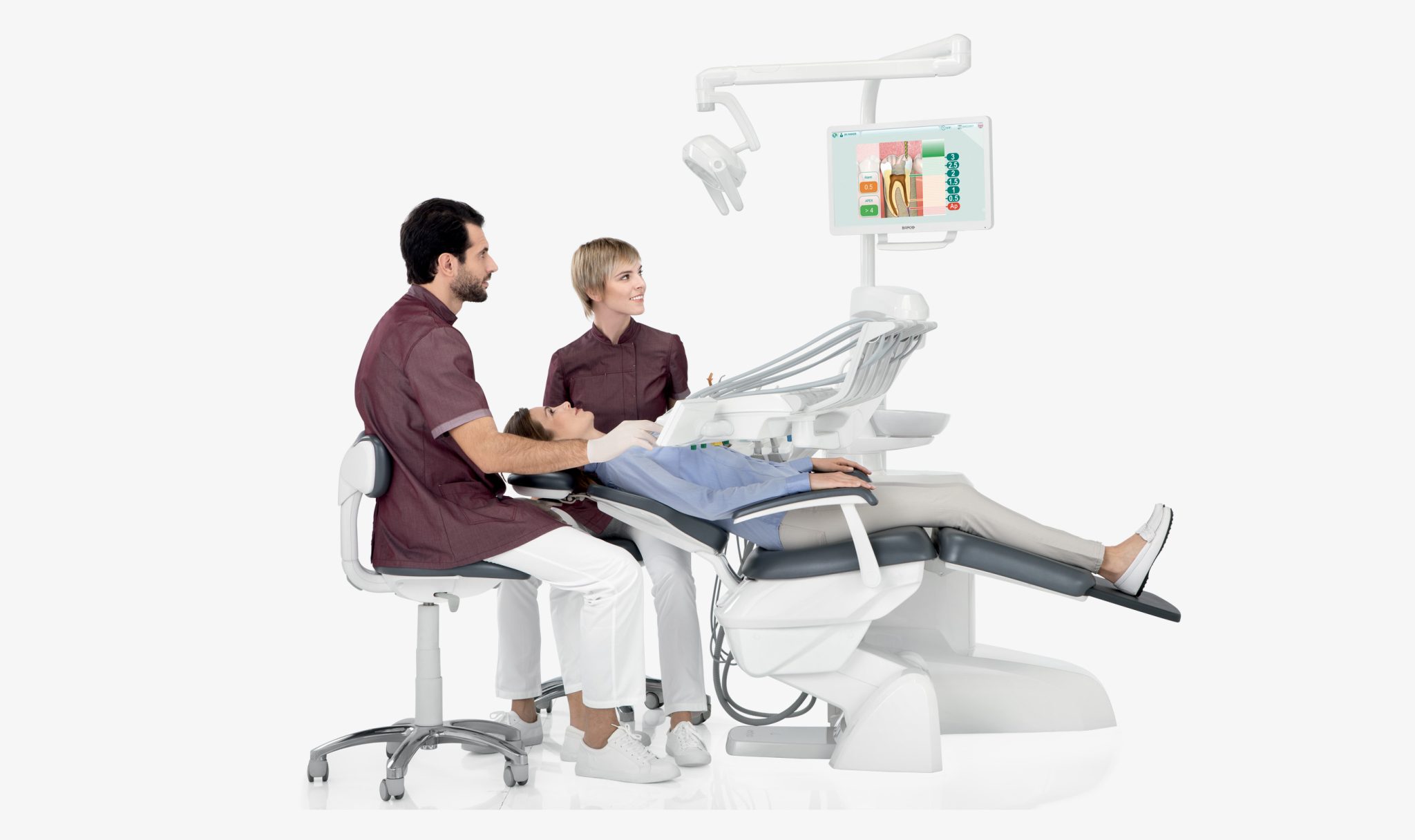 Dentist and assistant treating a patient at a modern dental unit